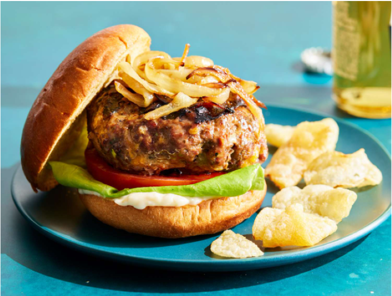  Homemade venison burger topped with caramelized onions, tomato, and lettuce served with chips