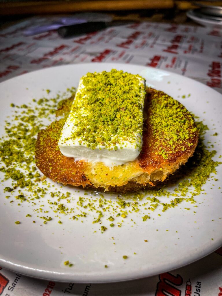easy kunafa recipe for beginners with pistachio topping served on white plate