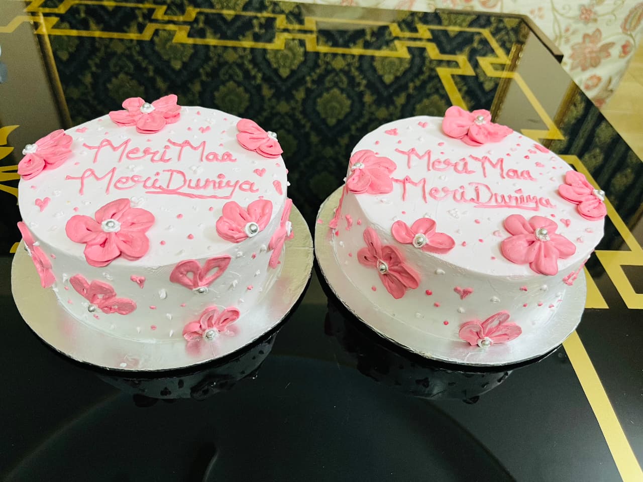 Mothers day special cake decorated with pink flowers and personalized message