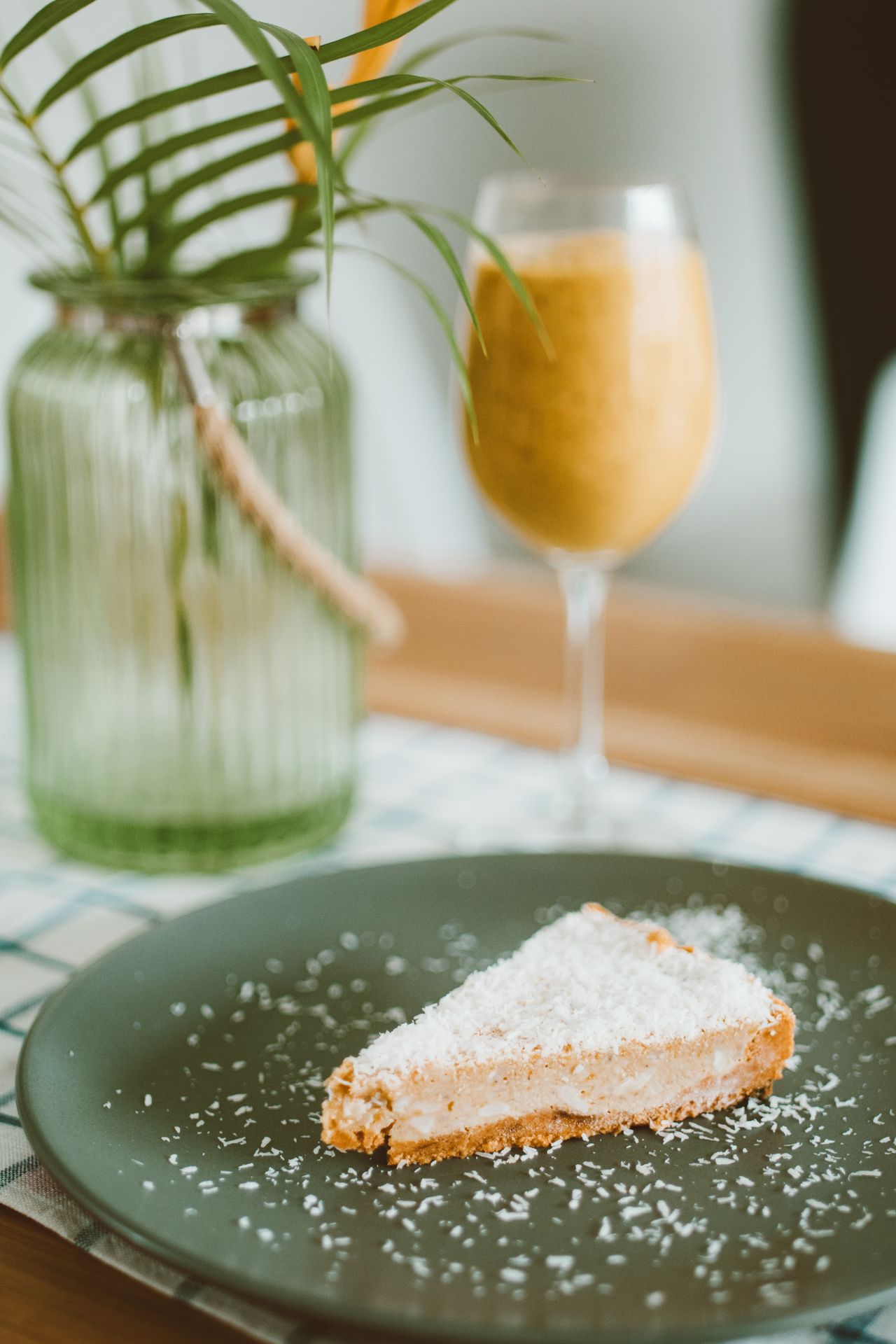 Moist coconut pineapple cake recipe slice served on a dark plate topped with shredded coconut