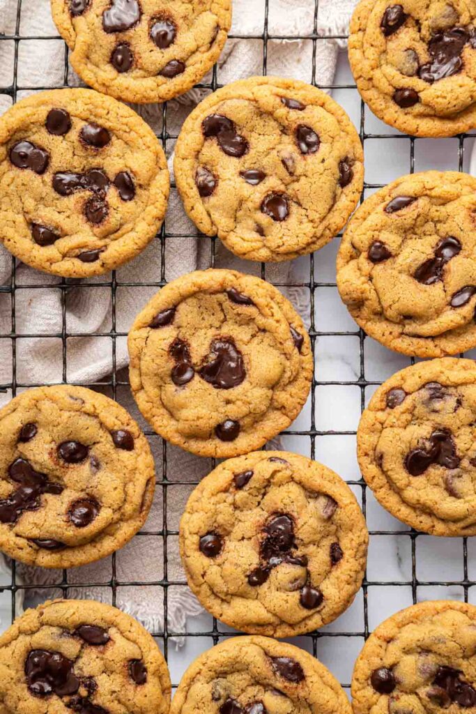  One bowl chocolate chip cookies - soft, thick, and chewy bakery style cookies with melty chocolate chips, shown on a baking tray, in a basket, and stacked