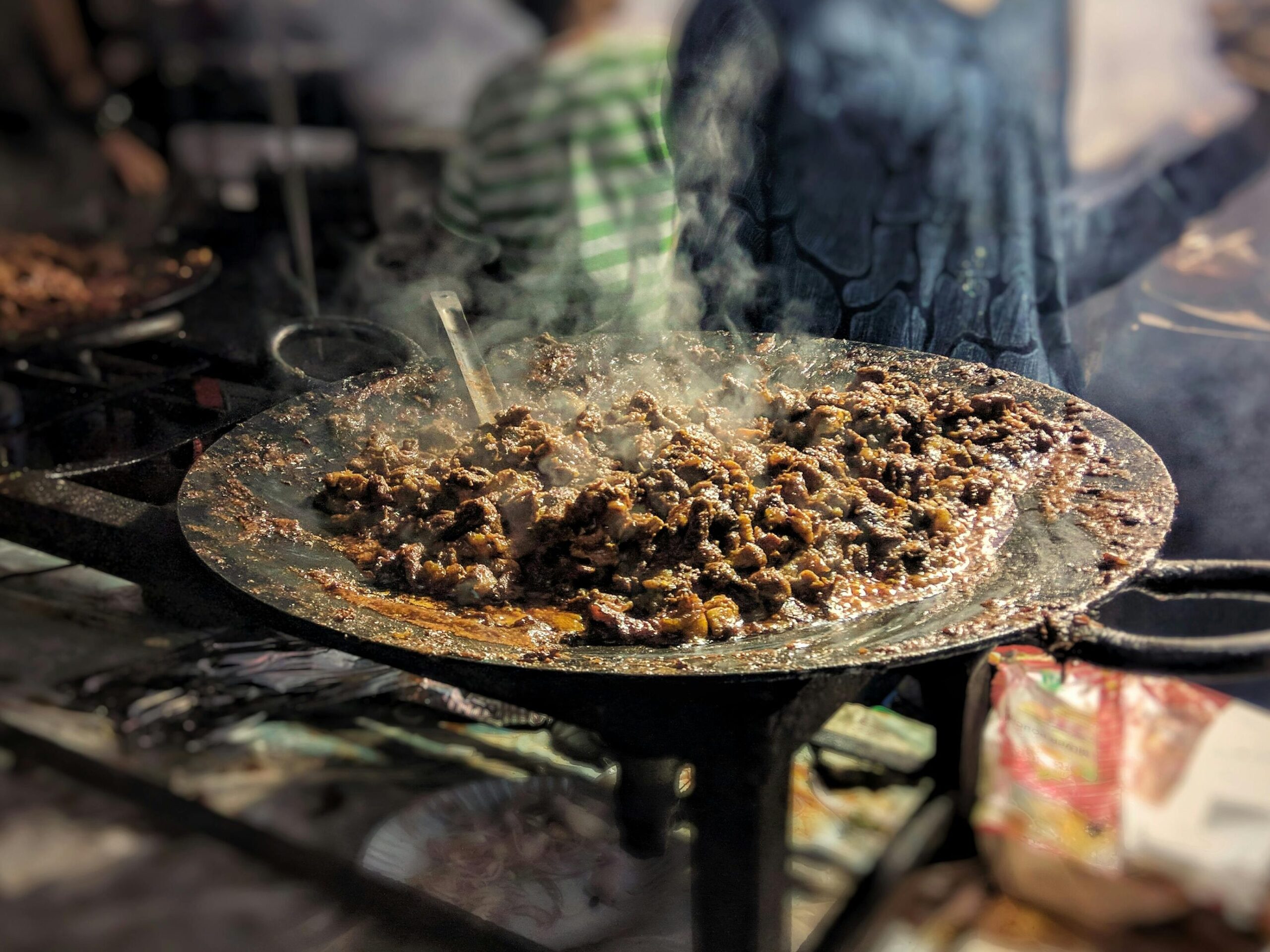 Spicy Pakistani mutton kaleji recipe being cooked fresh on a hot iron tawa
