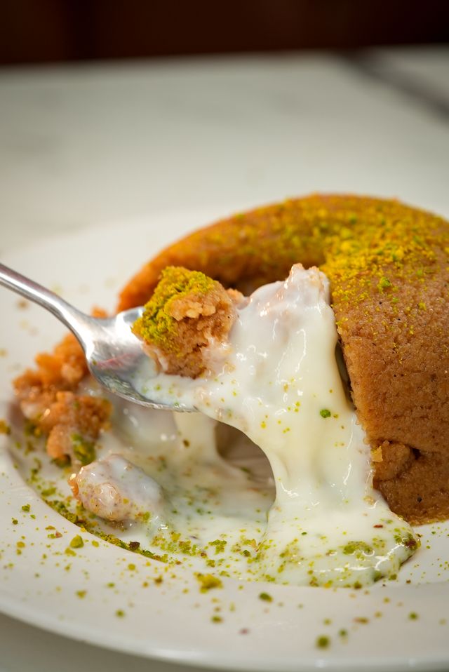 Quick Pakistani Eid sweets at home, featuring a traditional semolina suji halwa garnished with silver leaf and nuts.