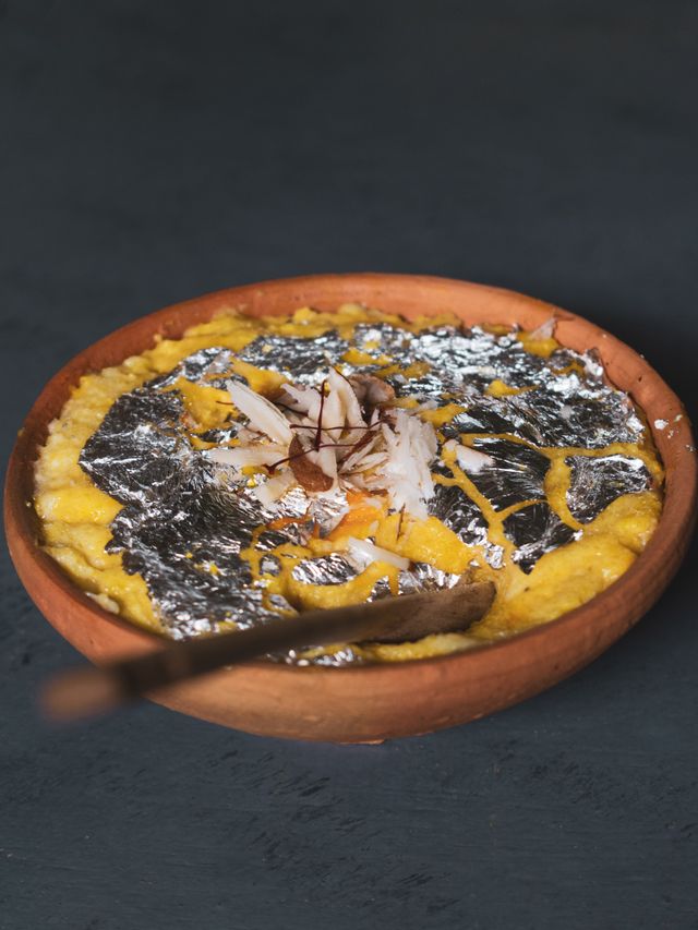 Slices of rich besan gram flour halwa served on a white plate as a quick Eid dessert recipe under 30 minutes.