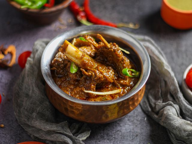Leftover mutton and lamb recipes curry garnished with ginger and green chilies