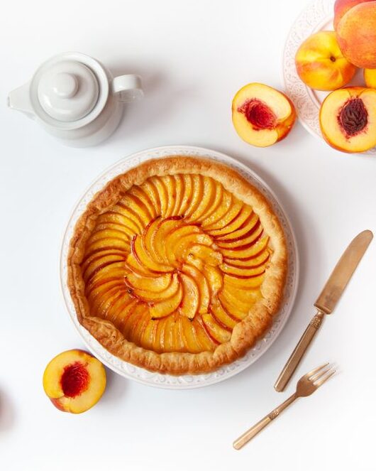 Peach Cobbler Bars served with fresh peaches