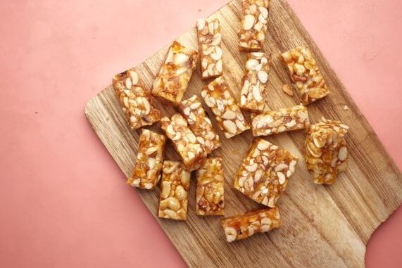 Homemade granola bar snack for kids lunchbox sliced on a wooden board